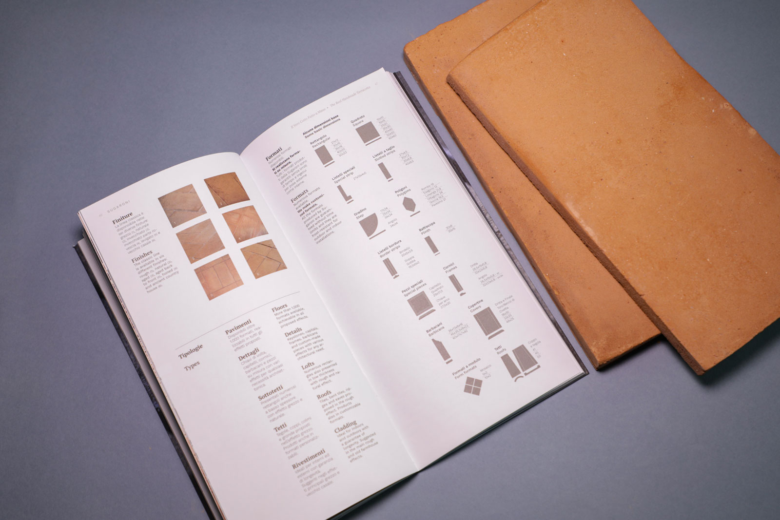 dettaglio di pagina interna del catalogo con mattonelle di cotto fatto a mano accanto al catalogo